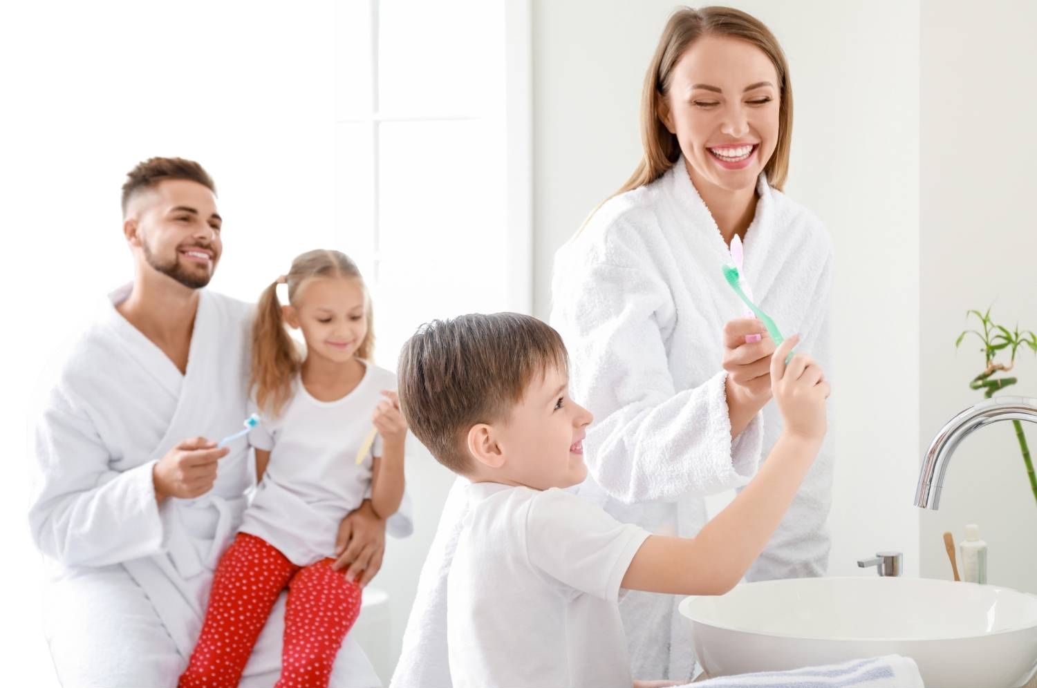 A family using a bright modern bathroom